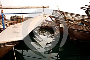 Traditional fishing dhows and reflection, harboured at Manama, Bahrain