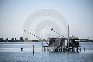 Traditional fishing hut on stilts with suspended nets in Comacchio valley, Emilia Romagna, Italy.