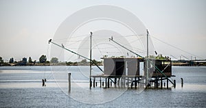 Traditional fishing hut on stilts with suspended nets in Comacchio valley, Emilia Romagna, Italy