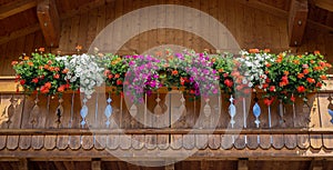 Traditional flowered balcony at the Italian Alps and dolomites