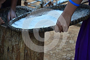 Traditional folk wisdom tribe karen people use large wooden mortar and big wood pestle for pounding rice grains thoroughly to