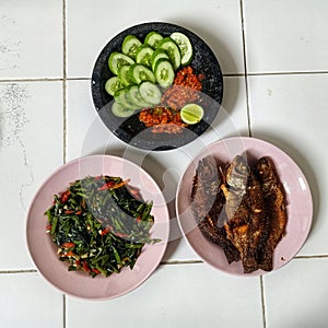 Traditional food on floor, cah kangkung mujaer goreng sambel cobek photo