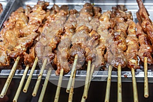 Traditional food meat grilled on wooden skewers on a big large metal pan photo