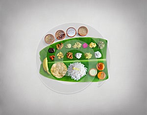 Traditional food Onam Sadya served on a banana leaf on Festival day onam,  Vegetarian meal with rice and curries, kerala food, Ker