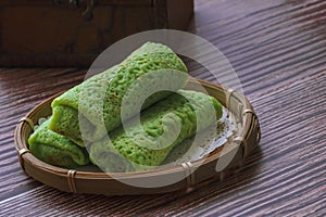 Kuih Dadar or Kuih Tayap Malaysian Pandan Crepes with Sweet Coconut Filling-Traditional food photography