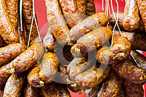 Traditional food. Smoked sausages meat hanging in european food