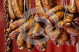 Traditional food. Smoked sausages meat hanging in european food