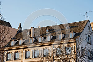 traditional French apartment building with balconies and clear blue sky in