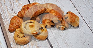 Traditional french butter croissant, Raisin Swirl and Chocolatine on wooden background