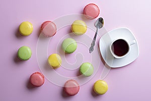 Traditional french colorful macarons with cup of tea