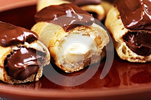 Traditional French dessert. Eclair with chocolate icing. Pastery concept with chocolate eclair