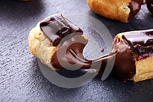 Traditional French dessert. Eclair with chocolate icing. Pastery dessert concept