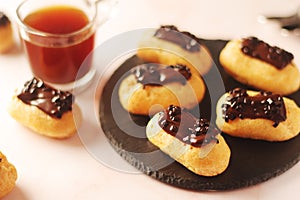 Traditional French dessert - eclairs with a cup of coffee