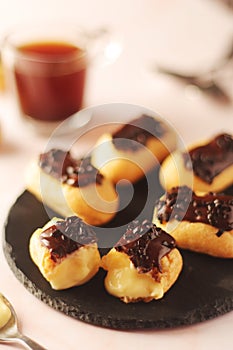 Traditional French dessert - eclairs with a cup of coffee