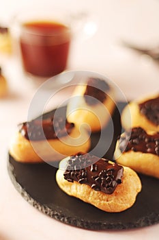 Traditional French dessert - eclairs with a cup of coffee