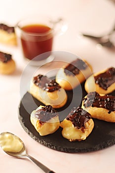 Traditional French dessert - eclairs with a cup of coffee