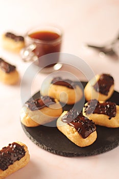 Traditional French dessert - eclairs with a cup of coffee