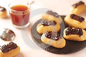 Traditional French dessert - eclairs with a cup of coffee