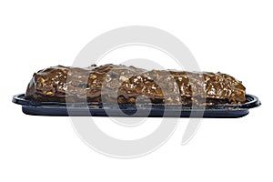 Traditional french dessert. Isolated eclair with custard and chocolate icing and peanuts on white background