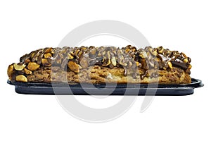 Traditional french dessert. Isolated eclair with custard and chocolate icing and peanuts on white background