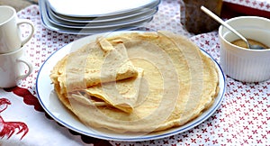 traditional french homemade pancakes in a plate served on a table