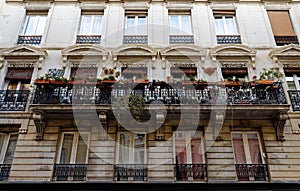 Traditional French house with typical balconies and windows. Paris.