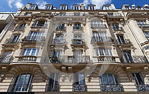 Traditional French house with typical balconies and windows. Paris.