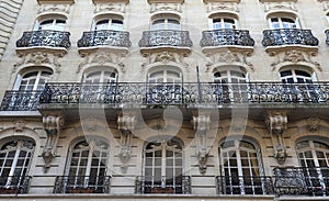 Traditional French house with typical balconies and windows. Paris.