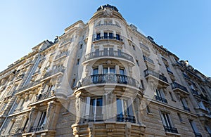 Traditional French house with typical balconies and windows. Paris .