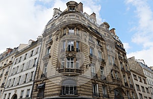 Traditional French house with typical balconies and windows. Paris .