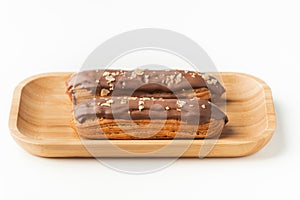 Traditional French pastry. Eclair with custard and chocolate icing isolated on white background. Eclair with cream filling covered