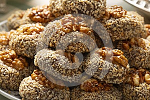 Traditional fresh baked Moroccan Ghoriba cookies topped with a walnut close up