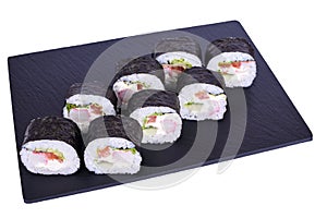 Traditional fresh japanese sushi futomaki on black stone Futomaki Snow Crab on a white background. Roll ingredients: surimi,