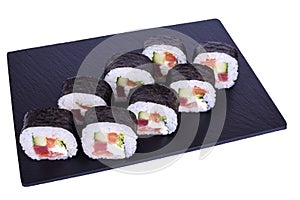 Traditional fresh japanese sushi Futomaki maki on black stone Maki Daikon on a white background. Roll ingredients: radish daikon,