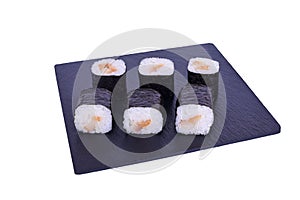 Traditional fresh japanese sushi maki on black stone Maki Escolar on a white background. Roll ingredients: escolar fish, nori,