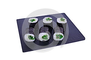 Traditional fresh japanese sushi maki on black stone Maki Hiashi on a white background. Roll ingredients: algae hiyashi, nori,