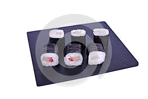 Traditional fresh japanese sushi maki on black stone Maki Izumi on a white background. Roll ingredients: perch izumai, nori, rice