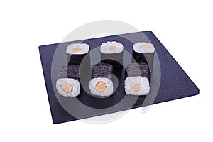 Traditional fresh japanese sushi maki on black stone Maki Tamago on a white background. Roll ingredients: tamago omelet, nori,