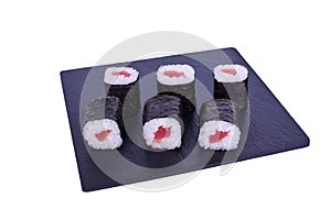 Traditional fresh japanese sushi maki on black stone Maki Theca on a white background. Roll ingredients: Tuna, nori, rice