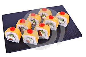 Traditional fresh japanese sushi rolls on black stone Syake Cheese on a white background. Roll ingredients: salmon, philadelphia