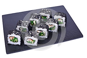 Traditional fresh japanese sushi rolls on black stone Unagi night on a white background. Roll ingredients: eel, philadelphia