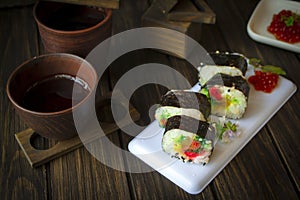 Traditional fresh japanese sushi rolls, black wooden table