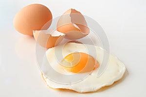 Traditional fried egg with cracked shell and whole egg