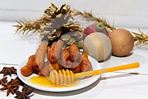 Traditional fried pestiÃ±os with honey and anise prepared for Christmas and Easter in Spain