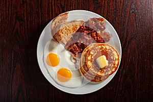 Traditional full american breakfast eggs pancakes with bacon and toast