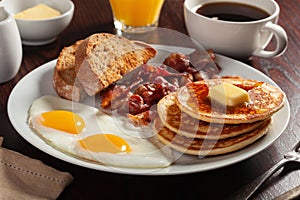 Traditional full american breakfast eggs pancakes with bacon and toast