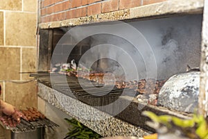 Traditional Gaziantep kebab called `KÃ¼ÅŸleme` is grilling on a bbq in a restaurant in the city of Gaziantep