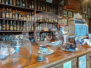 Traditional general store bar. Shelves with beverage bottles, cash register. Automobile Museum.