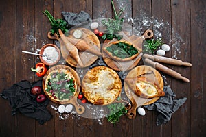 Traditional Georgian adjara khachapuri and Kolkh khachapuri on the table. Homemade baking. Top view. Flat lay