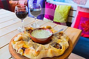 Traditional Georgian adjara pie and wine
